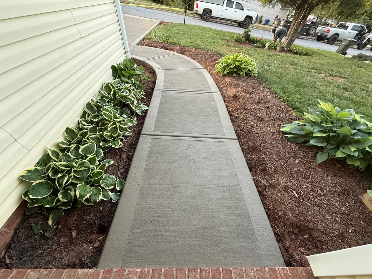 Concrete walkway in Apex, NC — poured pathway, control joints, broom-finish surface by Local Concrete Contractor.