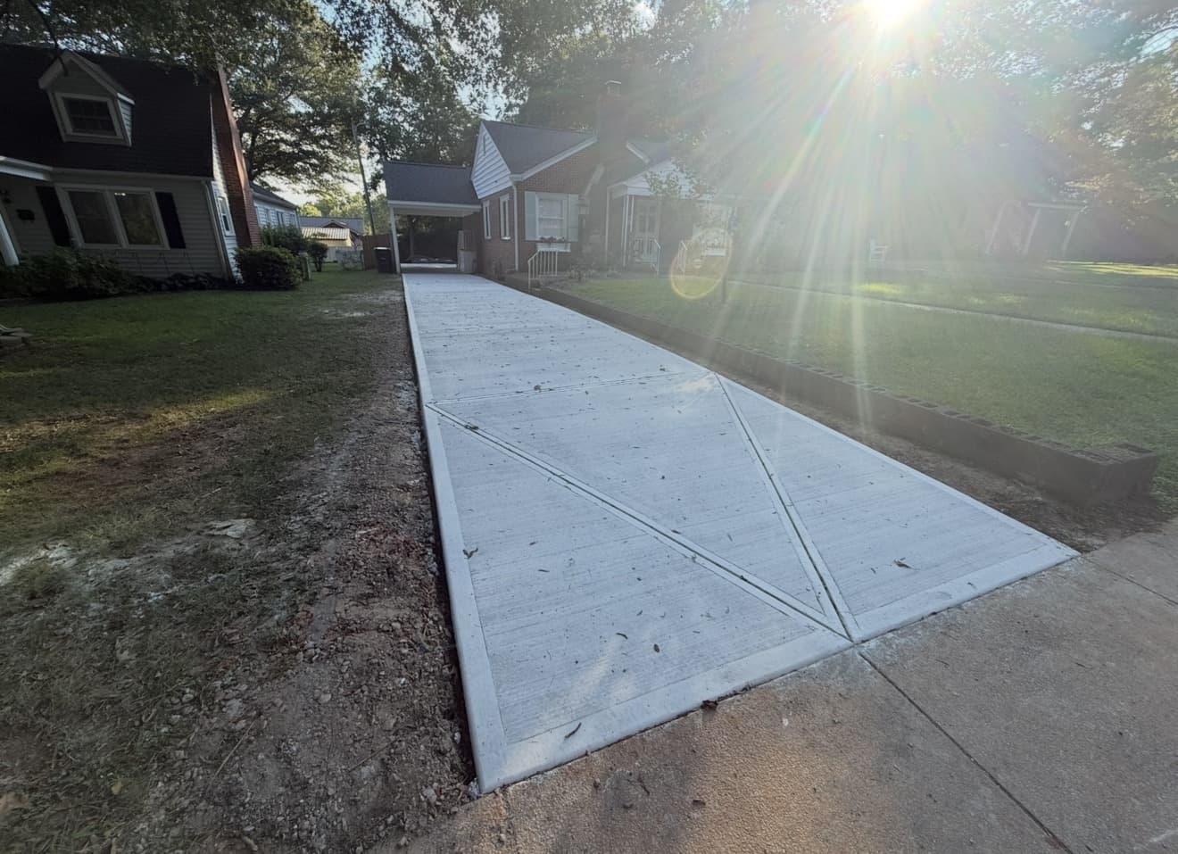 Concrete driveway installation in Chapel Hill, NC — poured slab, control joints, broom-finish surface by Local Concrete Contractor.