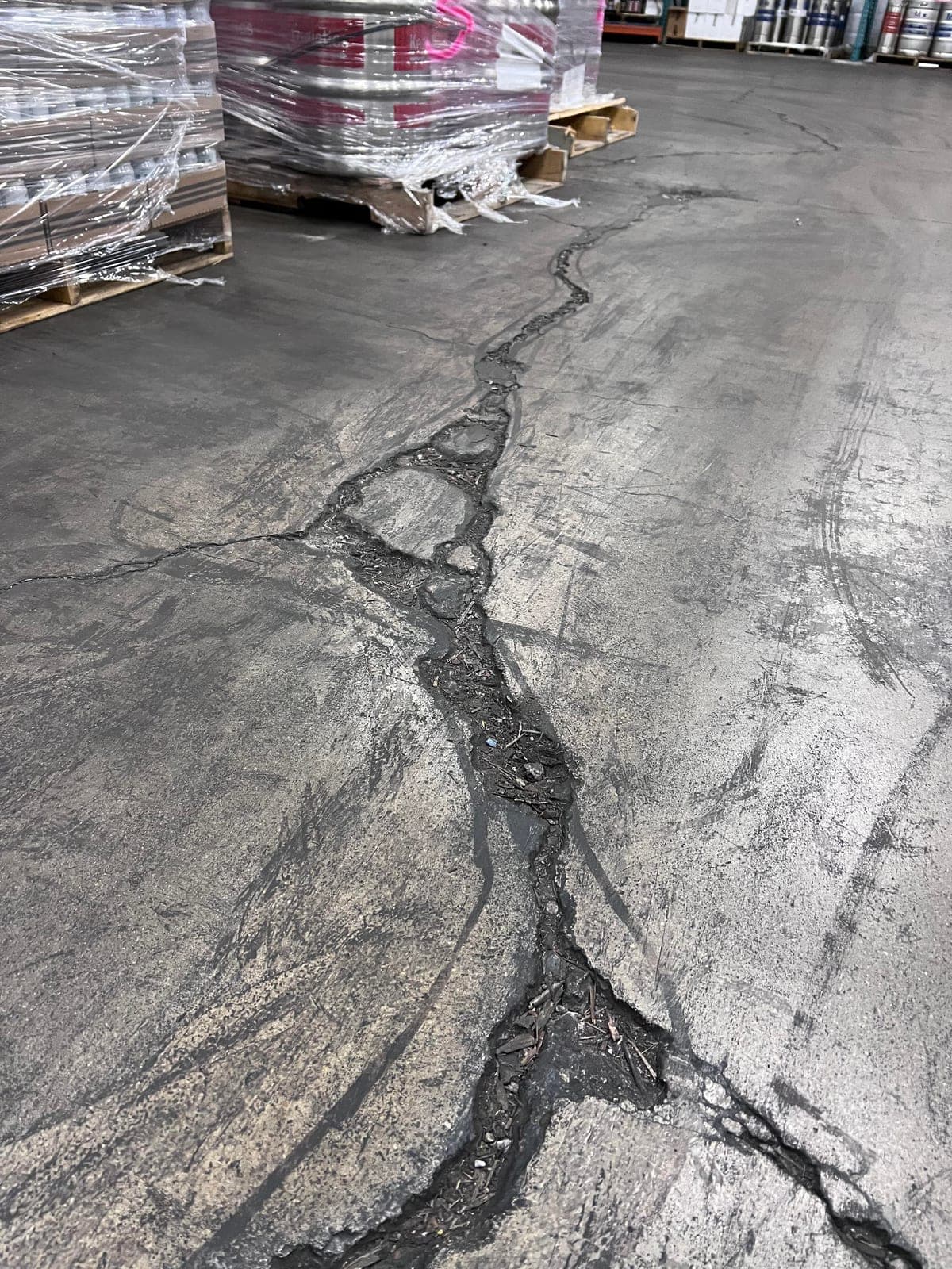 Newly poured Warehouse Floor Repair in Matthews, NC (Mecklenburg County) by Local Concrete Contractor — 4000 PSI mix, double-mat #4 rebar, broom-finish surface, 28-day full cure.