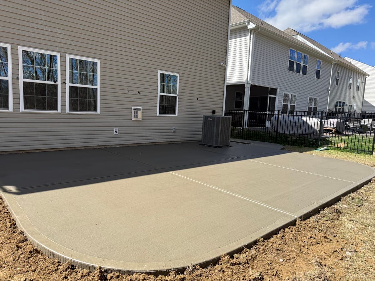 Concrete patio installation in Mint Hill, NC — poured slab, tooled edges, broom-finish surface by Local Concrete Contractor.
