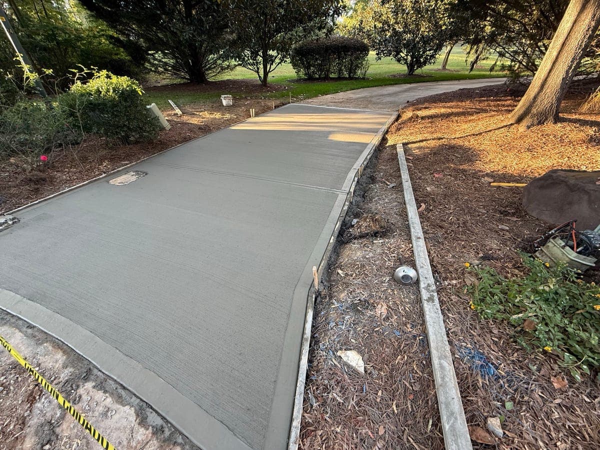 Newly poured Concrete Driveway Aprons in Salisbury, NC (Rowan County) by Local Concrete Contractor — 4000 PSI mix, double-mat #4 rebar, broom-finish surface, 28-day full cure.