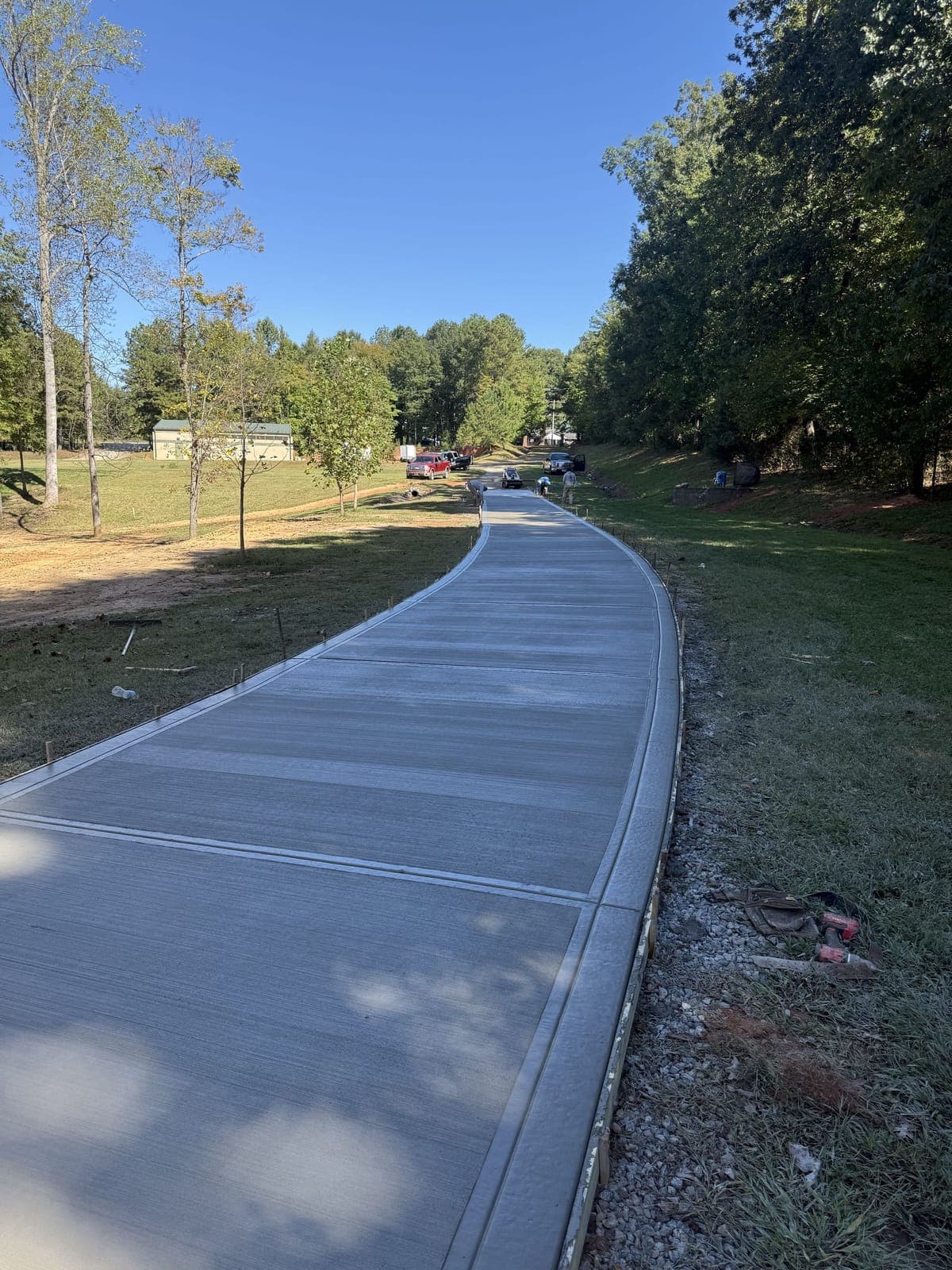 Newly poured Long Concrete Driveways in Salisbury, NC (Rowan County) by Local Concrete Contractor — 4000 PSI mix, double-mat #4 rebar, broom-finish surface, 28-day full cure.