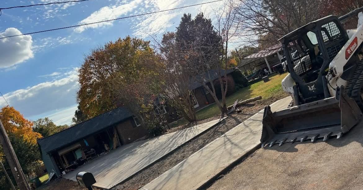 Newly poured Concrete Driveway Replacement in Wake Forest, NC (Wake County) by Local Concrete Contractor — 4000 PSI mix, double-mat #4 rebar, broom-finish surface, 28-day full cure.