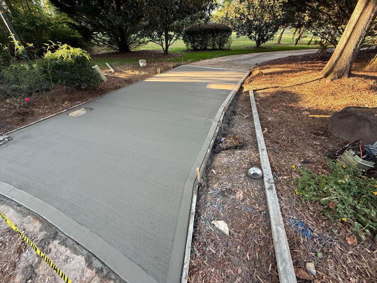 Finished Concrete Driveway Aprons job in Wilmington, North Carolina by Local Concrete Contractor — clean control-joint pattern, smooth troweled surface, full property protection during pour.